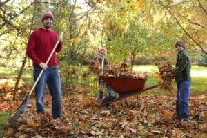 Family raking leaves