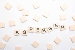 Asperger spelled out in plastic letter pieces on white backgroun