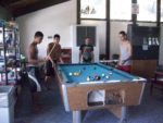 Kids from Pittsburg, Ca enjoy a game of pool.