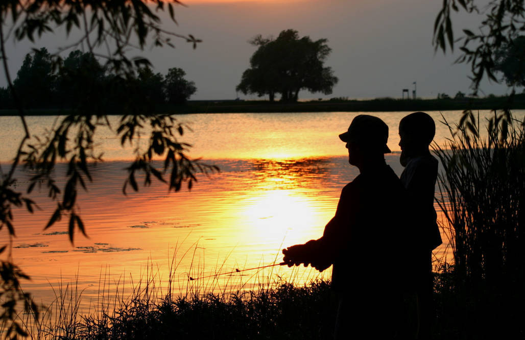 Father-and-son-fishing-at-dusk-18625553