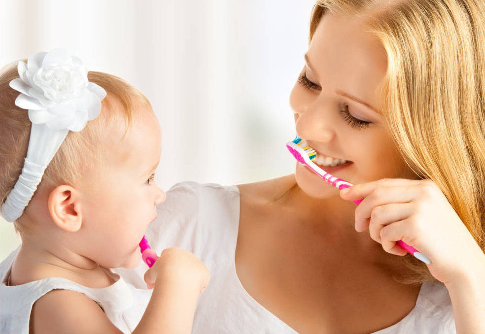 Mother & child brushing teeth